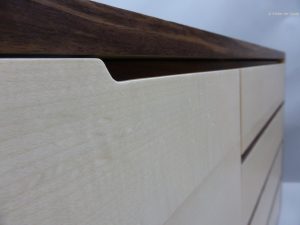 detail-of-handles-on-doors-and-drawers-receded-in-solid-walnut