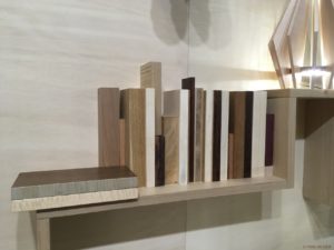 Samples-of-wood-types-with-different-finishes-displayed-like-books-on-wall-decoration